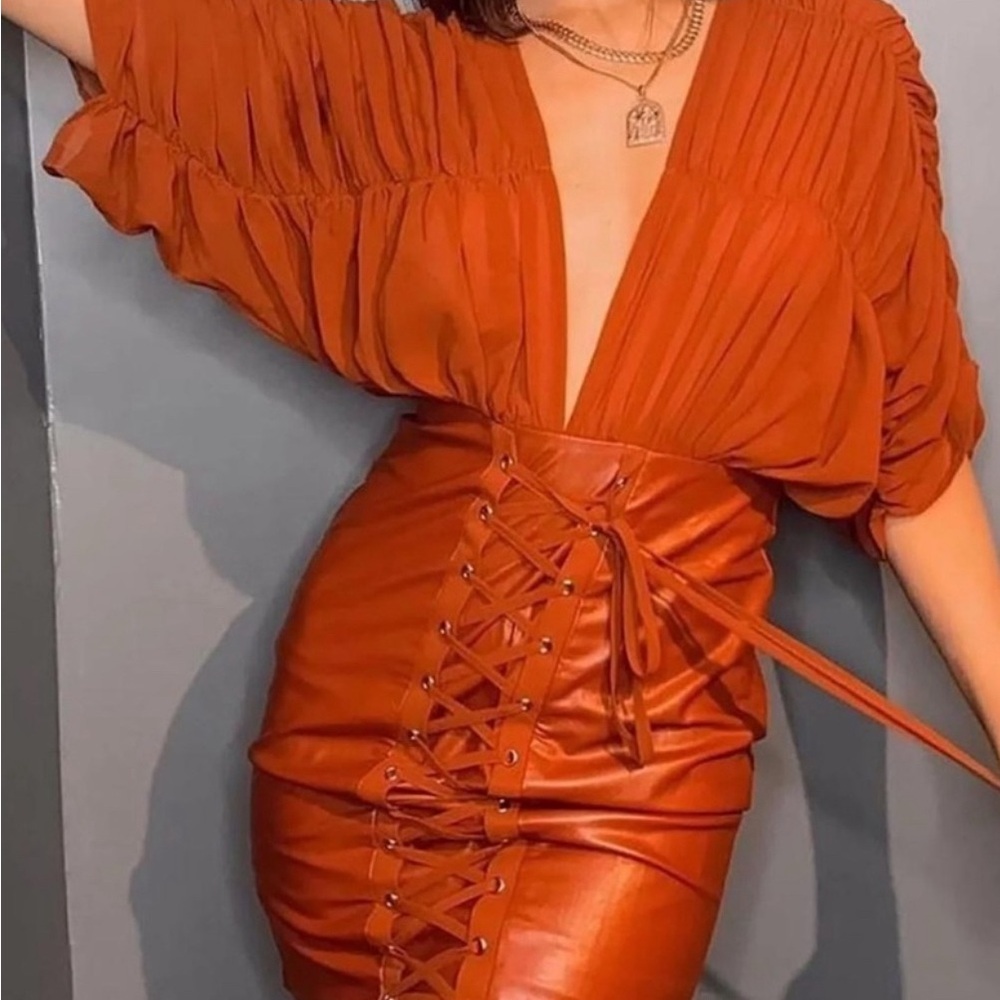 Color is Cognac. Sheer sleeves. Low back and front. Faux leather skirt. Size S